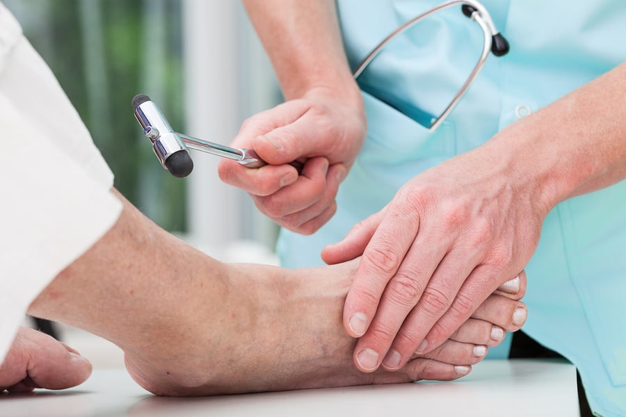 A doctor examining his patient's foot