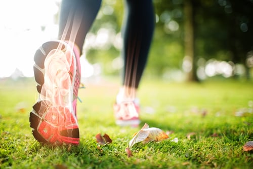 Digital composite of Highlighted foot bones of jogging woman