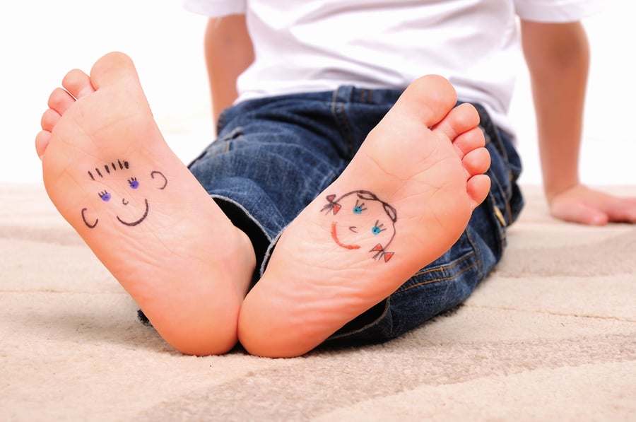 Children feet with faces 