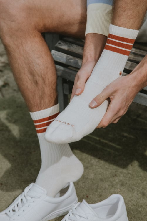 Sweeney Foot and Ankle Guy in Sports Socks Rubbing Foot and Ankle in Pain