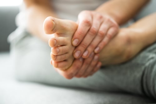 Woman folding foot with toes