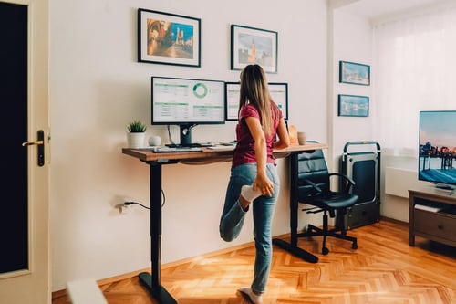 Young woman standing at her desk